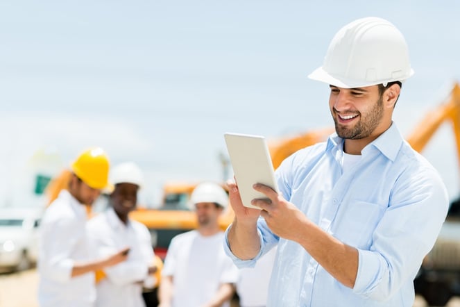 Male engineer at a construction site with a tablet computer .jpeg