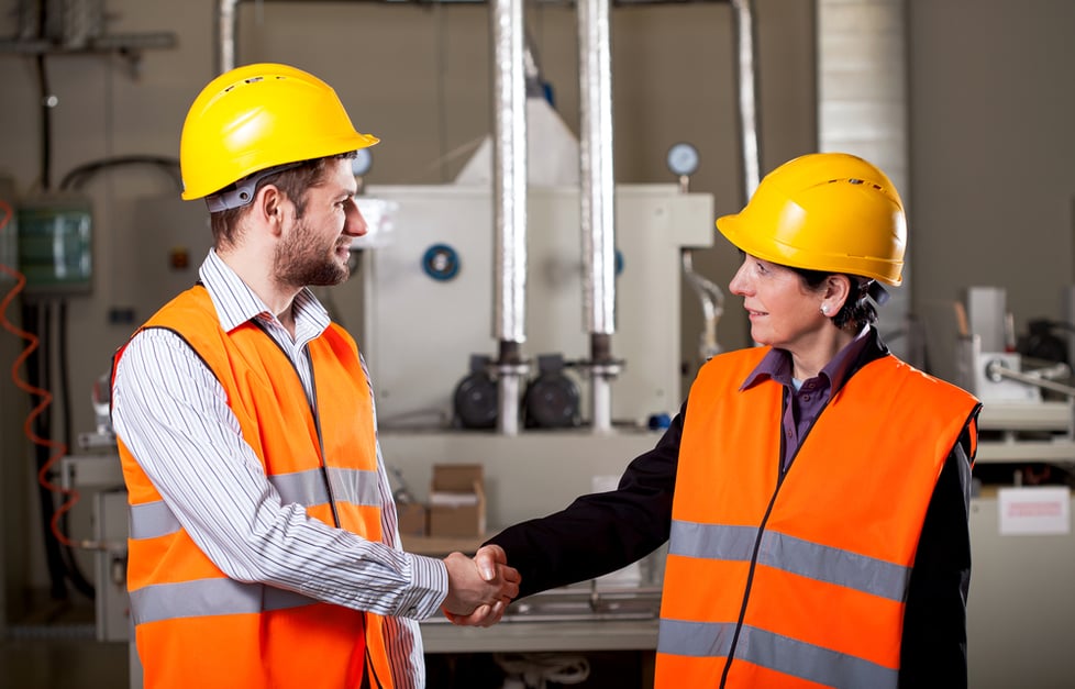 Female worker shake hand with male worker